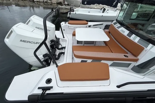 Slide: The Image of 2025 Axopar 37 XC Cross Cabin with Mercury engines and brown seating. - 12