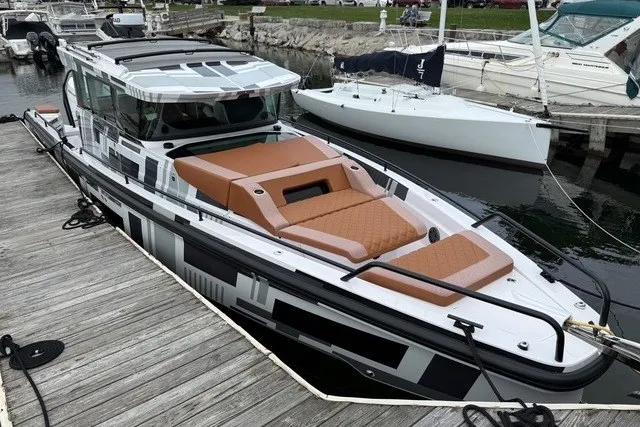 Slide: The Image of 2025 Axopar 37 XC Cross Cabin boat docked, featuring sleek design and comfortable seating. - 4