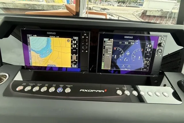 Slide: The Image of Dashboard of 2025 Axopar 37 XC Cross Cabin with dual Simrad displays. - 18