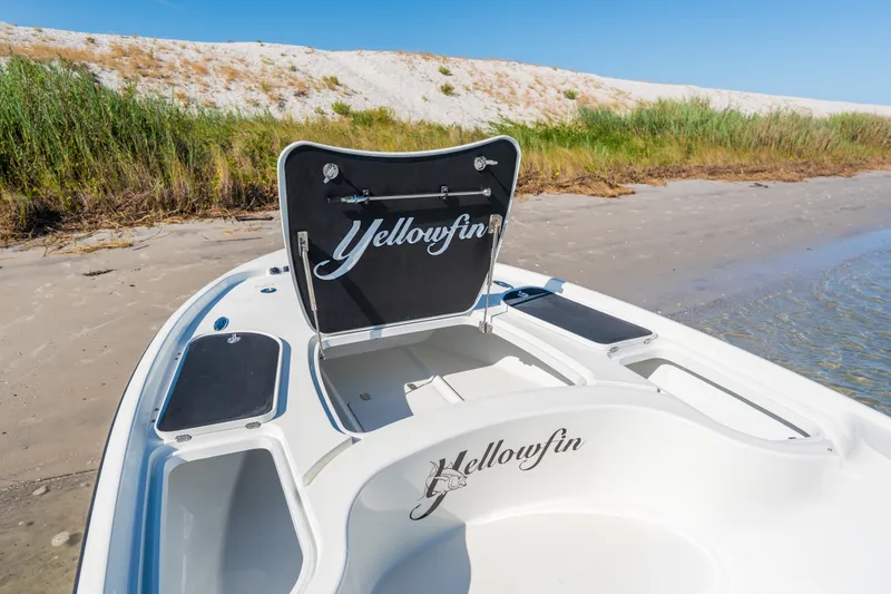 Slide: The Image of 2013 Yellowfin 24 Bay boat on sandy shore with lush greenery background. - 5