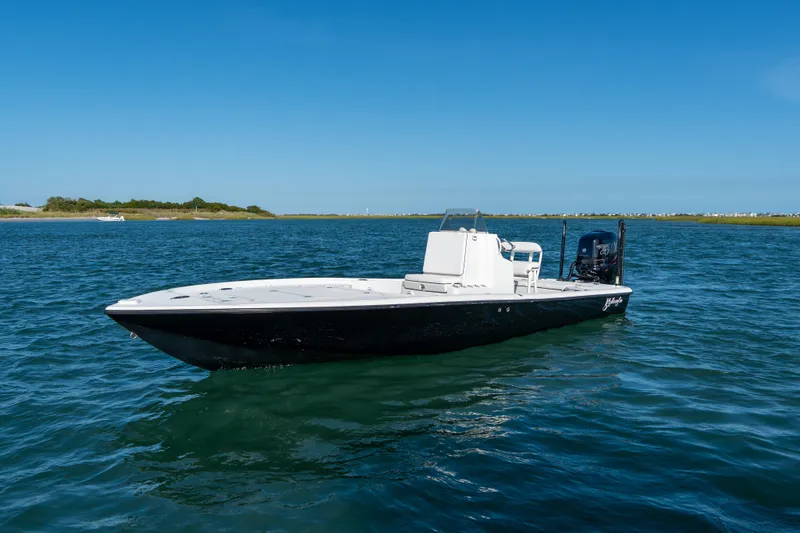 Slide: The Image of 2013 Yellowfin 24 Bay boat on calm water under clear blue sky. - 1