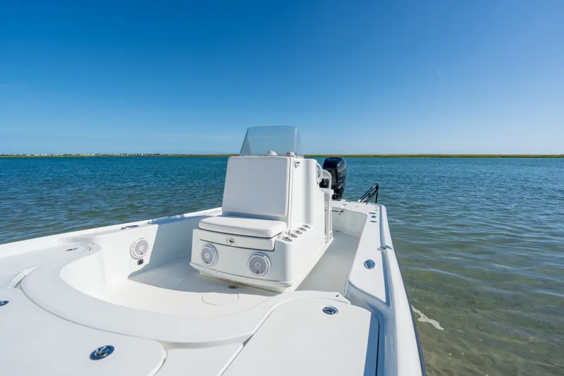 Slide: The Image of 2013 Yellowfin 24 Bay boat on calm water under clear blue sky. - 4