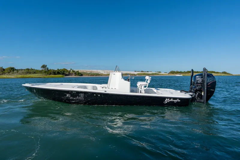 The Image of 2013 Yellowfin 24 Bay boat on water, clear blue sky background. - 0