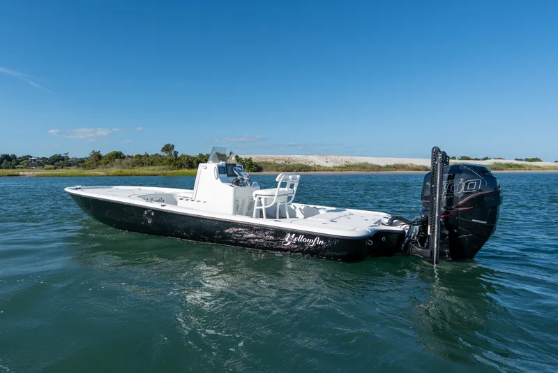 Slide: The Image of 2013 Yellowfin 24 Bay boat on calm water under clear blue sky. - 3