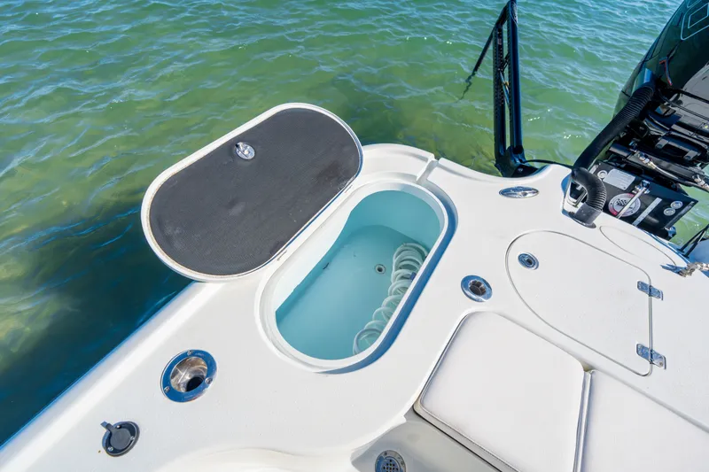 Slide: The Image of 2013 Yellowfin 24 Bay boat with open storage compartment on deck. - 10