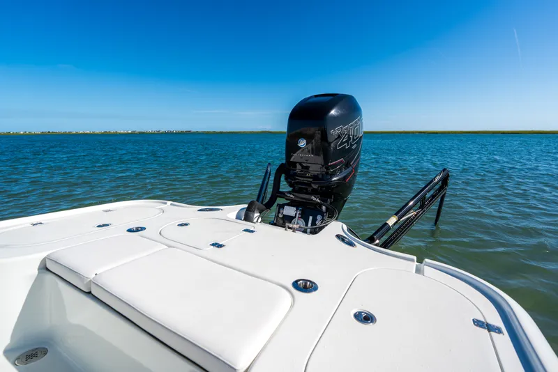 Slide: The Image of 2013 Yellowfin 24 Bay boat on water, featuring powerful outboard motor and spacious deck. - 9