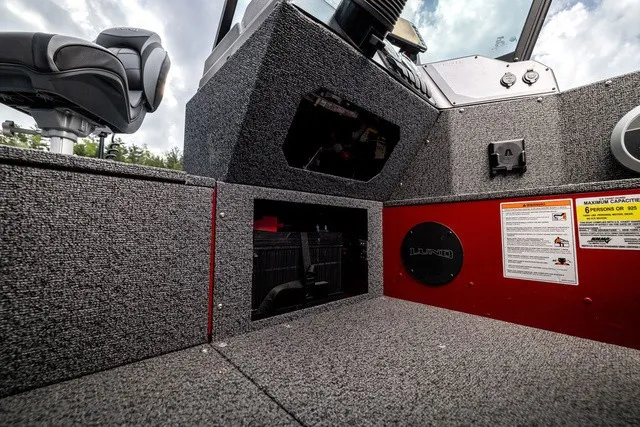 Slide: The Image of Interior view of a Lund 1700 Adventure Sport boat with gray carpeting and storage space. - 14