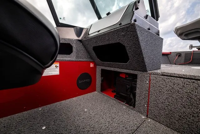 Slide: The Image of Interior of a 2027 Lund 1700 Adventure Sport with gray carpeting and red accents. - 11
