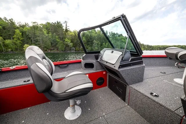 Slide: The Image of The image shows the cockpit of a 2027 Lund 1700 Adventure Sport boat with gray seats. - 10