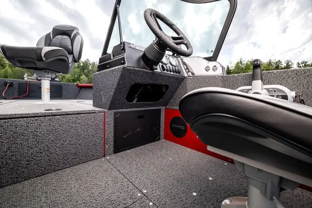 Slide: The Image of The image shows the cockpit of a 2027 Lund 1700 Adventure Sport boat with modern seating and controls. - 13