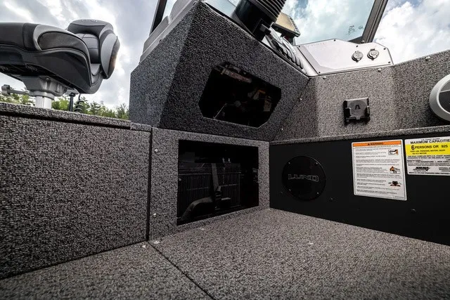 Slide: The Image of Interior of a Lund 1700 Adventure Sport boat with gray carpeting and black details. - 14