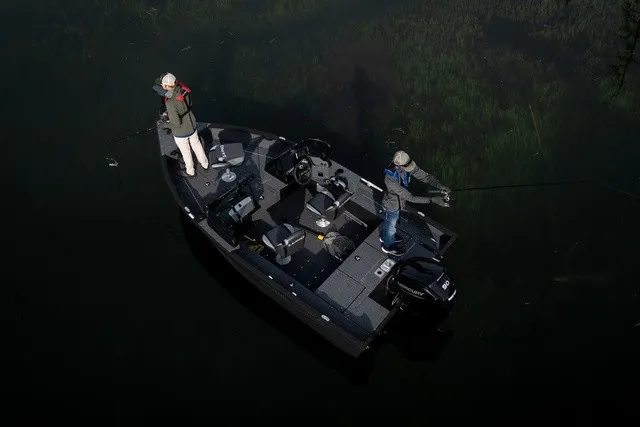 Slide: The Image of Two people fishing on a Lund 1700 Adventure Sport boat on calm water. - 5