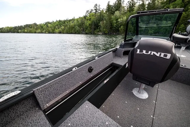 Slide: The Image of The image shows a modern boat on a calm lake, surrounded by trees. - 9