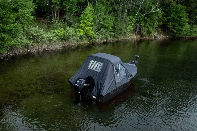 Slide: The Image of A 2027 Lund 1700 Adventure Sport boat is in the water, surrounded by trees. - 4