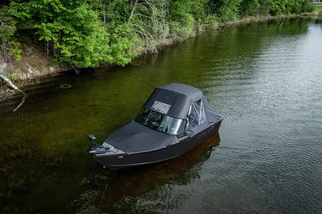 Slide: The Image of Lund 1700 Adventure Sport 2027 in a calm, wooded waterway. - 3