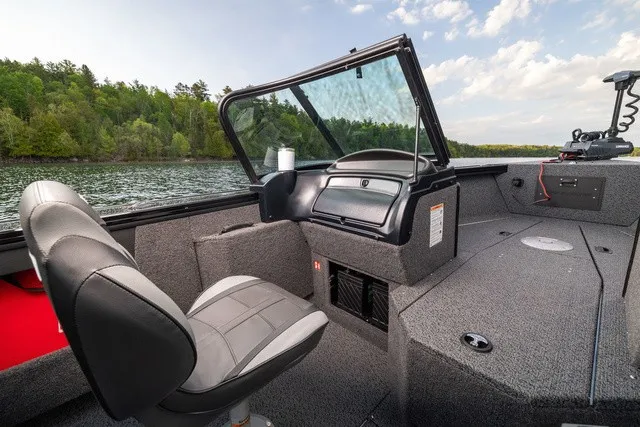 Slide: The Image of The image shows the cockpit of a 2027 Lund 1875 Fisherman boat with gray interior. - 3