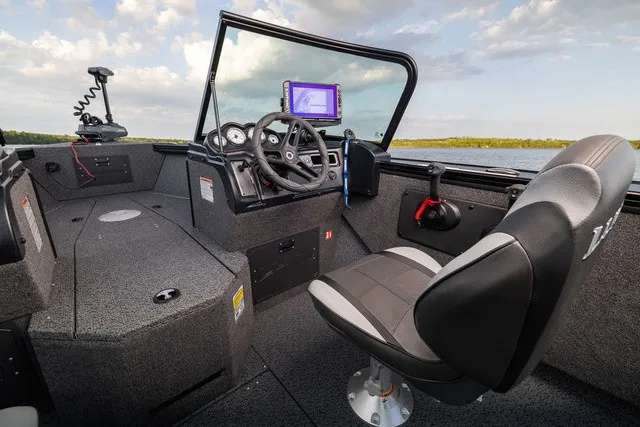 Slide: The Image of The image shows the cockpit of a 2027 Lund 1875 Fisherman boat with a modern helm. - 5