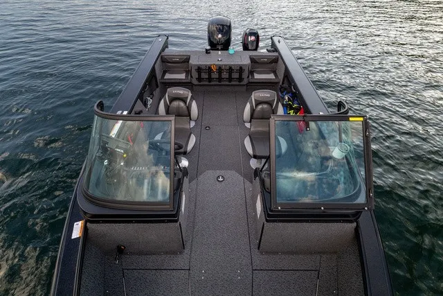 Slide: The Image of The image shows a modern fishing boat on the water with multiple seats and an outboard motor. - 2