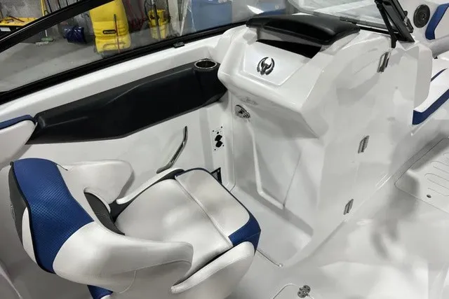 Slide: The Image of The image shows the helm of a 2025 Scarab 255 LX boat with a modern seat. - 15