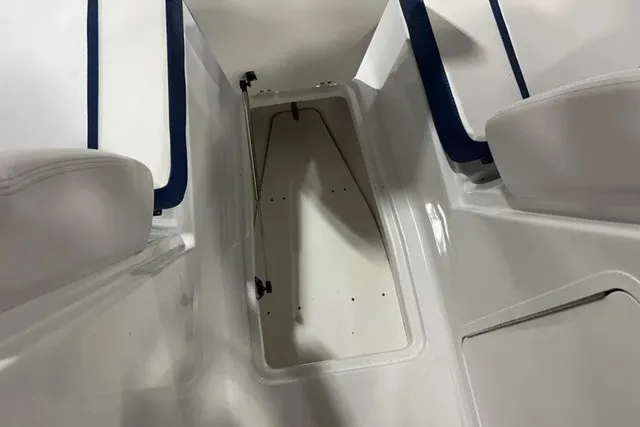 Slide: The Image of The image shows the interior of a 2025 Scarab 255 LX boat with an open storage compartment. - 26