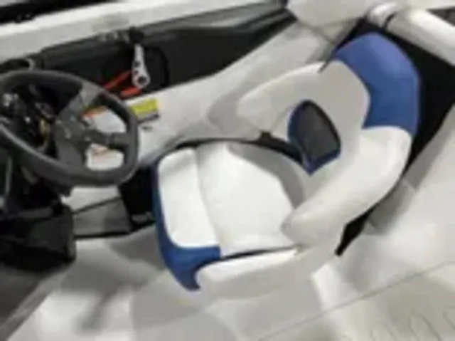 Slide: The Image of The image shows the helm of a 2025 Scarab 255 LX with a modern, cushioned seat. - 19