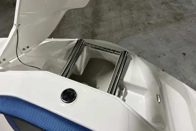 Slide: The Image of The image shows a white boat hatch with blue upholstery and an integrated ladder. - 34