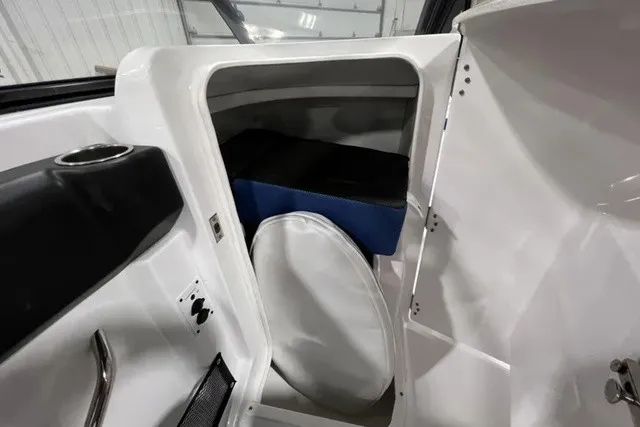 Slide: The Image of Interior view of a 2025 Scarab 255 LX featuring storage space and seating. - 16
