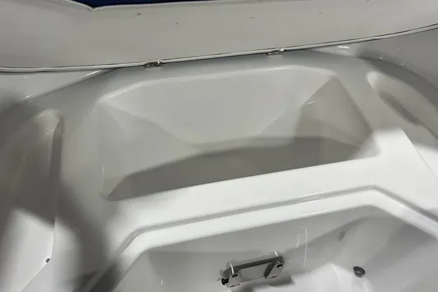 Slide: The Image of The image shows the white bow area of a 2025 Scarab 255 LX boat. - 32