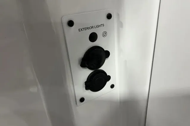 Slide: The Image of Close-up of a control panel with switches for exterior lights on a Scarab 255 LX boat. - 24