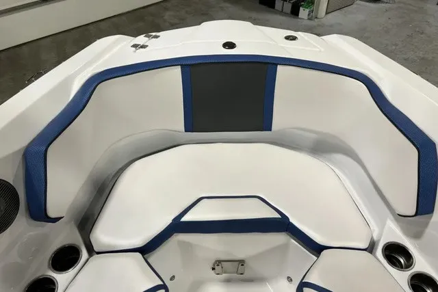 Slide: The Image of The 2025 Scarab 255 LX features white and blue upholstery with multiple cup holders. - 31