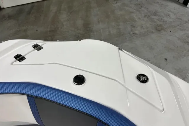 Slide: The Image of The image shows the deck of a Scarab 255 LX boat with blue accents. - 33