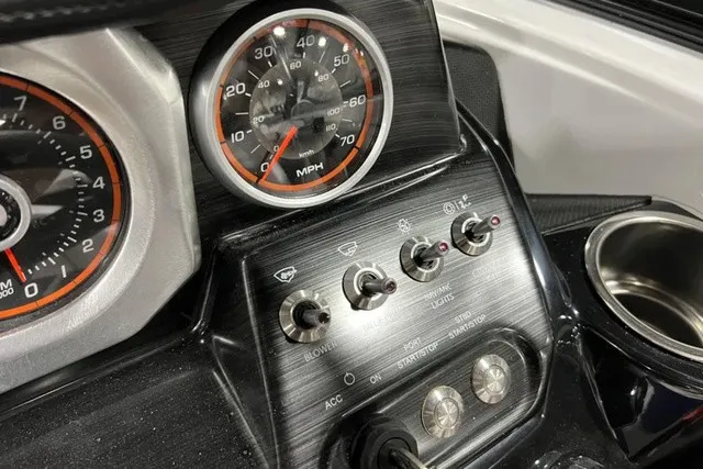 Slide: The Image of Close-up of a 2025 Scarab 255 LX dashboard with speedometer and switches. - 22