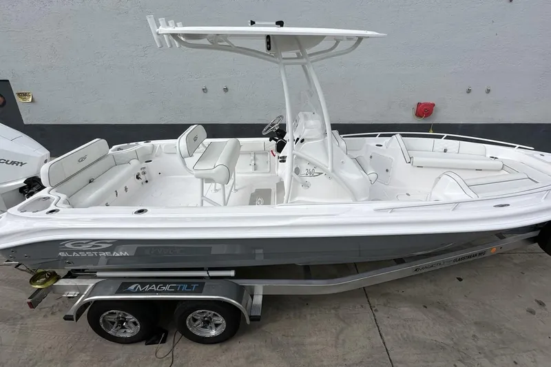 Slide: The Image of 2025 Glassream 240 CCX boat on trailer, featuring sleek white design and spacious seating. - 2