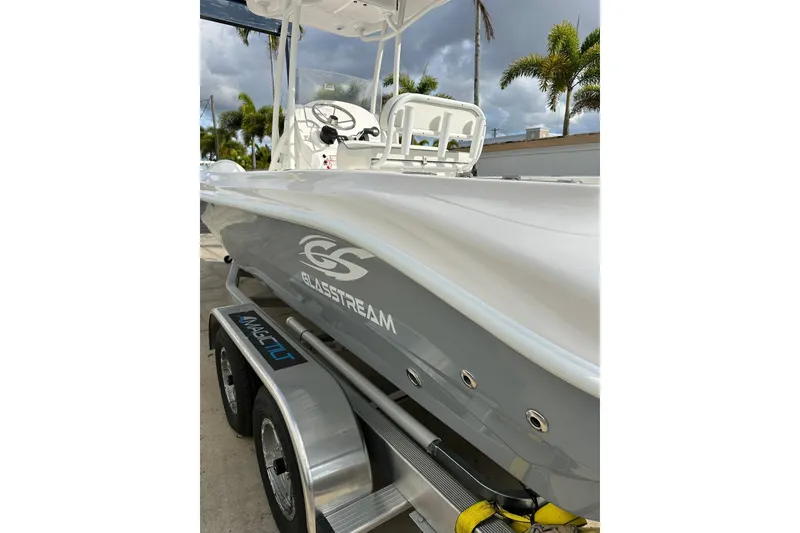 Slide: The Image of 2025 Glassream 240 CCX boat on trailer, sleek design, palm trees in background. - 4
