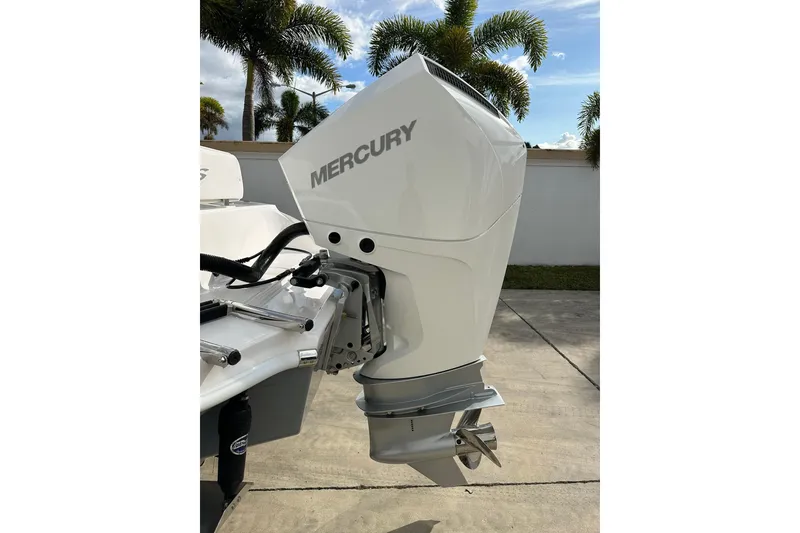 Slide: The Image of 2025 Glassream 240 CCX boat with Mercury outboard motor, parked outdoors. - 5