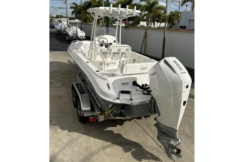 Slide: The Image of 2025 Glassream 240 CCX boat with Mercury V6 engine on trailer, parked outdoors. - 6