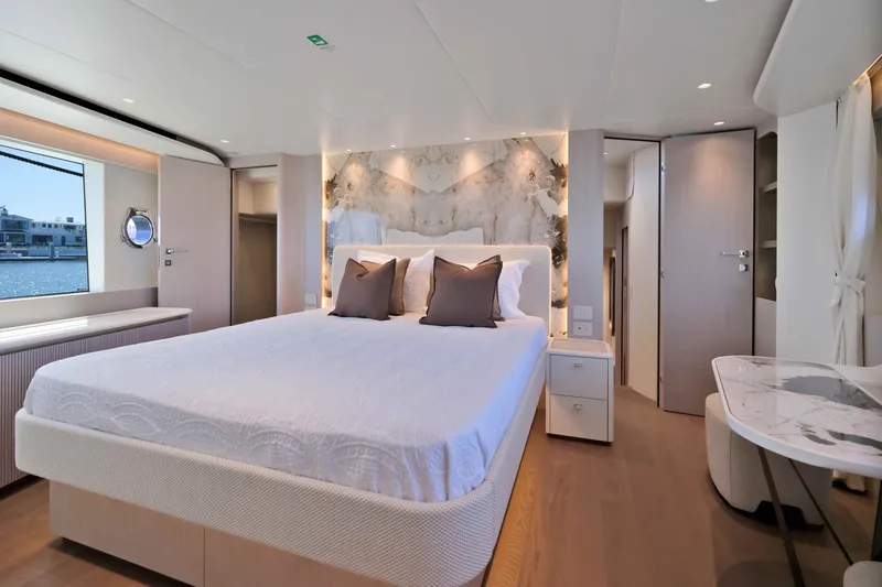 Slide: The Image of Luxurious bedroom interior of 2027 Absolute Navetta 62 yacht with elegant decor and waterfront view. - 18