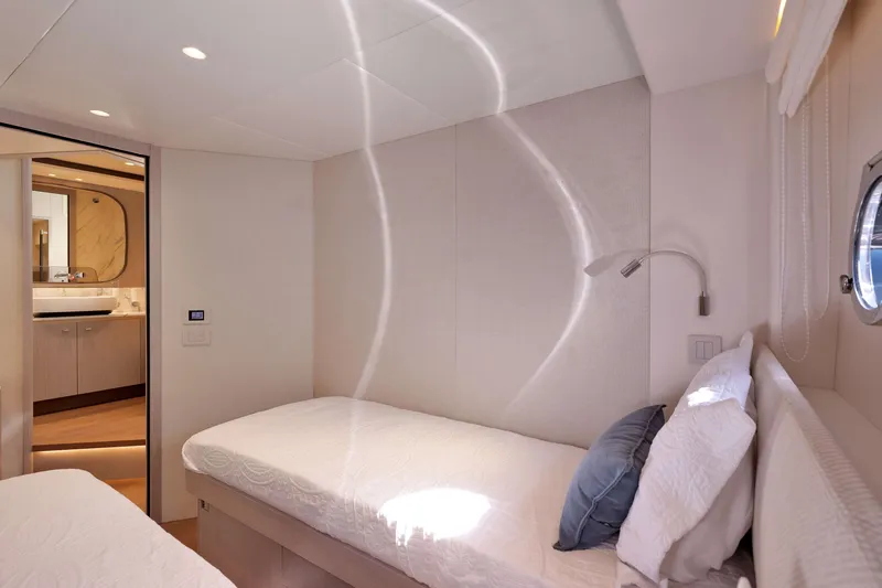 Slide: The Image of Luxurious cabin interior of Absolute Navetta 62 yacht, featuring modern design and cozy bedding. - 38