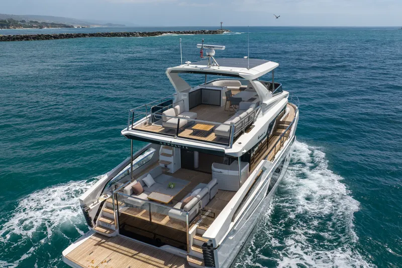 Slide: The Image of Luxurious 2027 Absolute Navetta 62 yacht cruising on open sea. - 5
