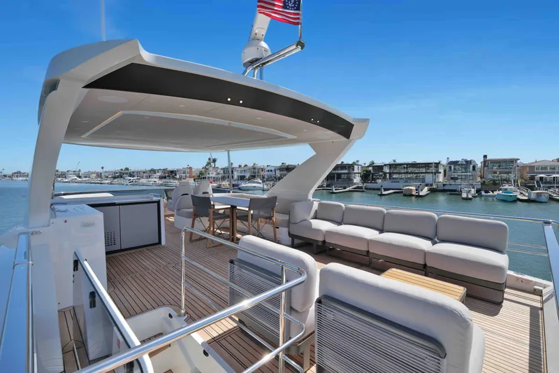 Slide: The Image of Luxurious 2027 Absolute Navetta 62 yacht deck with seating, dining area, and waterfront view. - 12