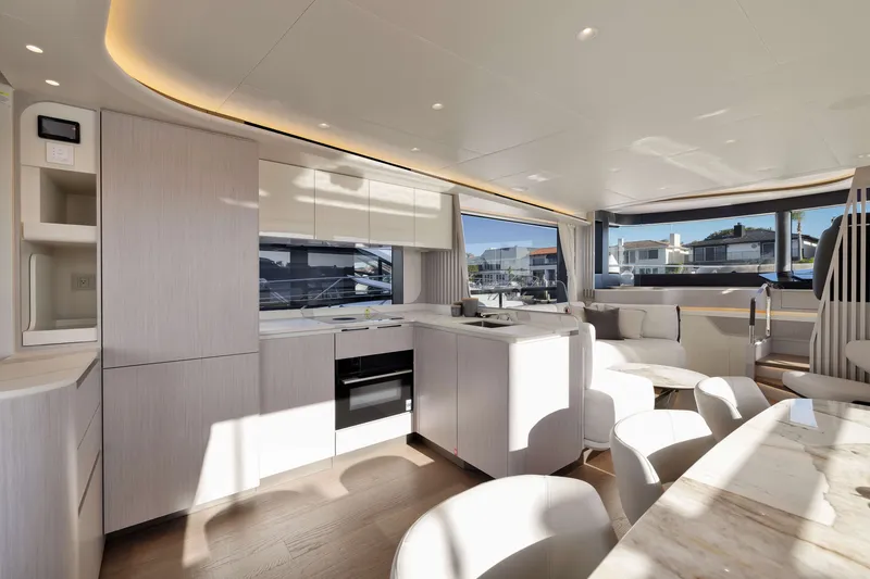 Slide: The Image of Luxurious interior of 2027 Absolute Navetta 62 yacht with modern kitchen and seating area. - 53