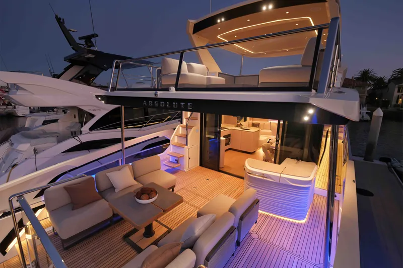 Slide: The Image of Luxurious 2027 Absolute Navetta 62 yacht with elegant deck lighting and modern interior design. - 27