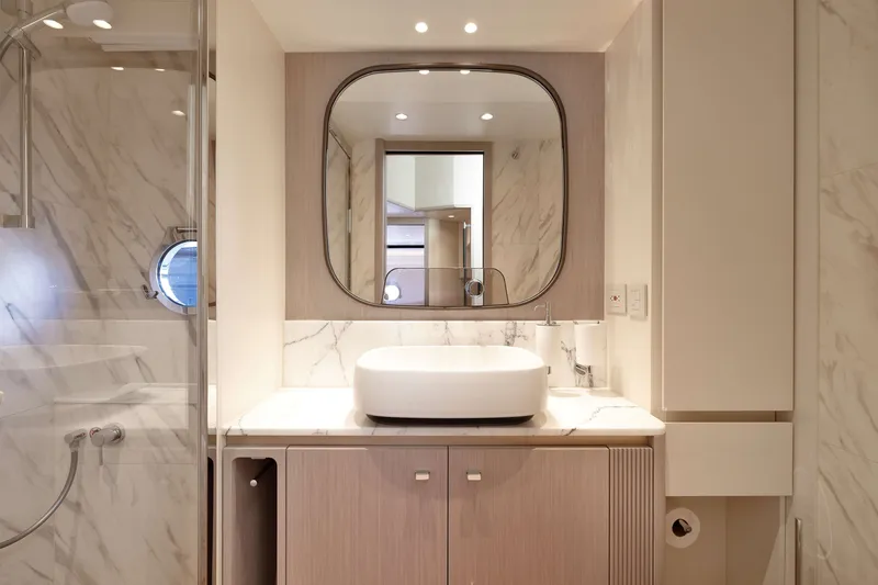 Slide: The Image of Luxurious bathroom in 2027 Absolute Navetta 62 yacht with modern fixtures and marble accents. - 43