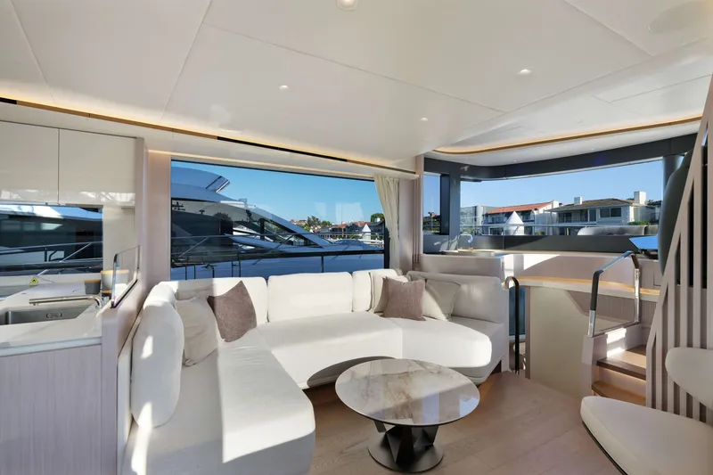 Slide: The Image of Luxurious interior of 2027 Absolute Navetta 62 yacht with modern seating and panoramic windows. - 22