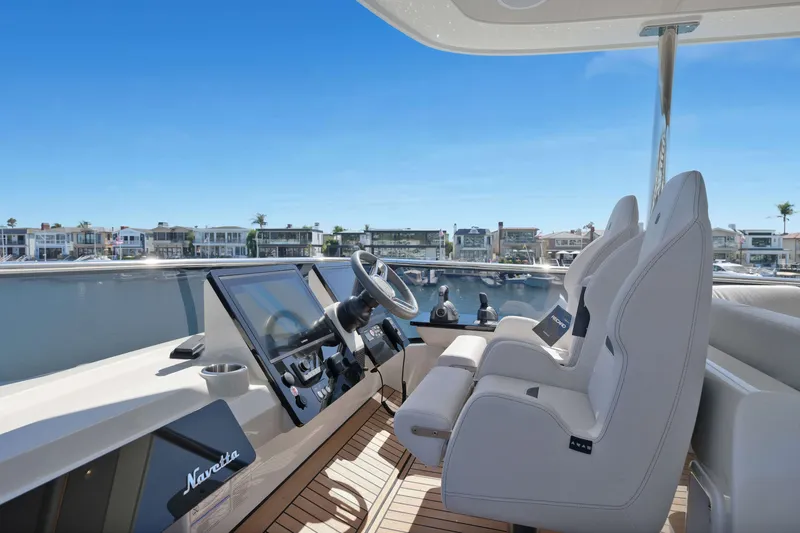 Slide: The Image of Luxurious helm of the 2027 Absolute Navetta 62 yacht with modern controls and seating. - 14