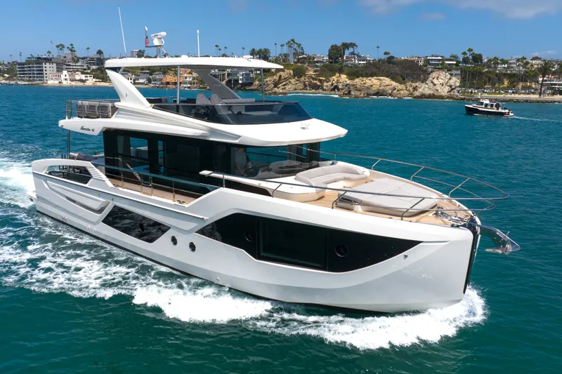 Slide: The Image of Luxurious 2027 Absolute Navetta 62 yacht cruising in clear blue waters. - 1