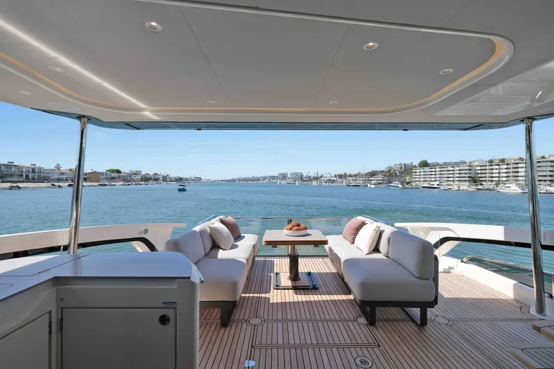 Slide: The Image of Luxurious 2027 Absolute Navetta 62 yacht deck with elegant seating and scenic waterfront view. - 15