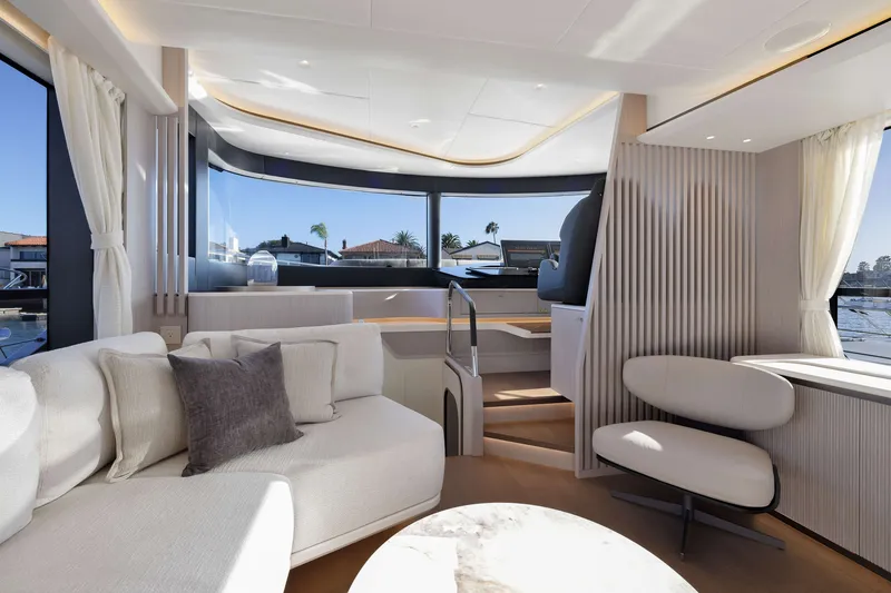 Slide: The Image of Luxurious interior of 2027 Absolute Navetta 62 yacht with modern seating and panoramic windows. - 51