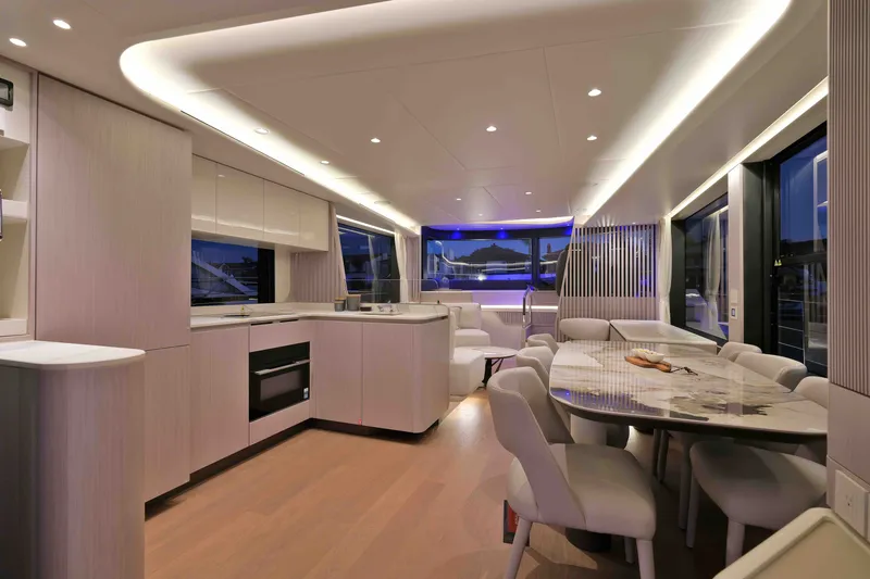 Slide: The Image of Luxurious interior of 2027 Absolute Navetta 62 yacht with modern kitchen and dining area. - 31