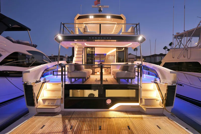 Slide: The Image of Luxurious 2027 Absolute Navetta 62 yacht at dusk, featuring elegant lighting and modern design. - 33